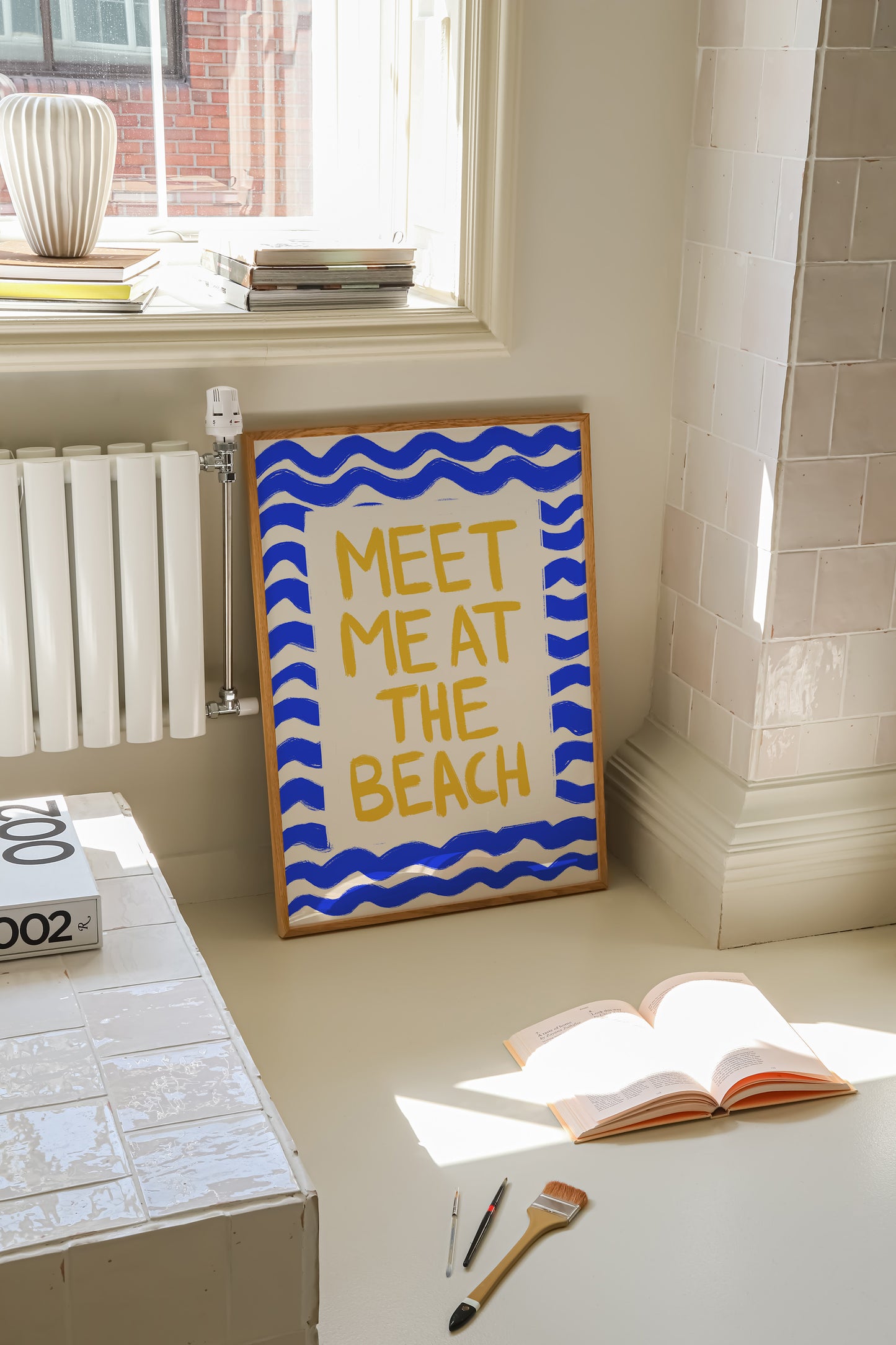 hand-drawn golden yellow meet me at the beach lettering blue wave border cream background art print