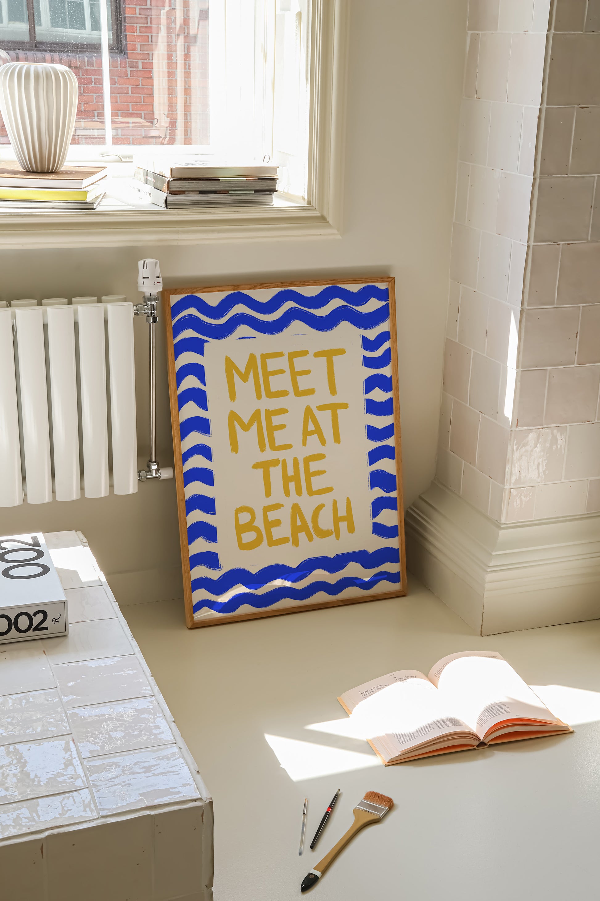 hand-drawn golden yellow meet me at the beach lettering blue wave border cream background art print