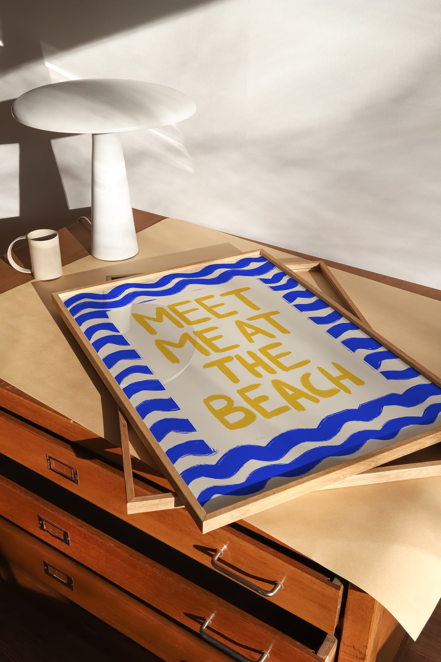 hand-drawn golden yellow meet me at the beach lettering blue wave border cream background art print
